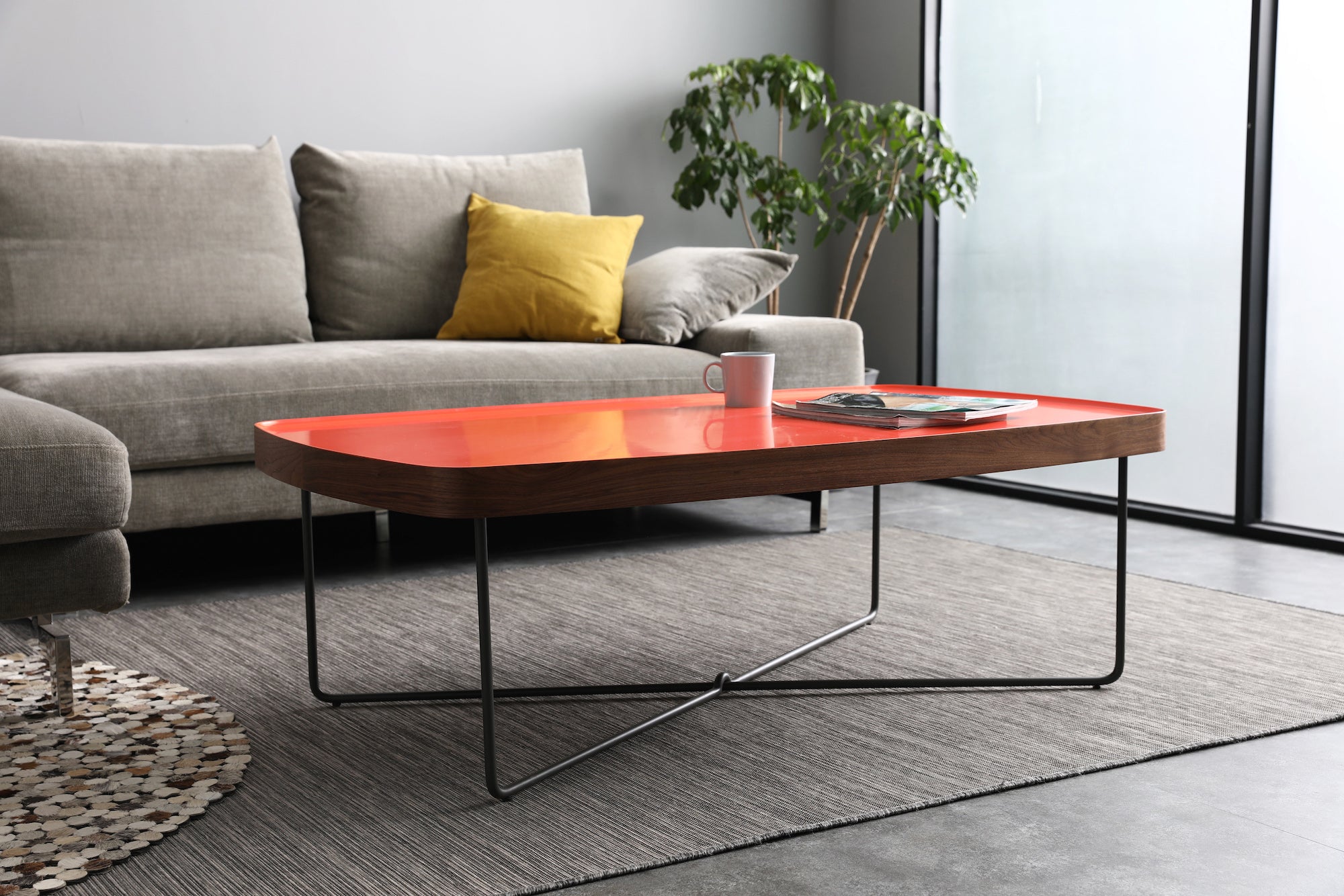 Red coffee table in grey lounge