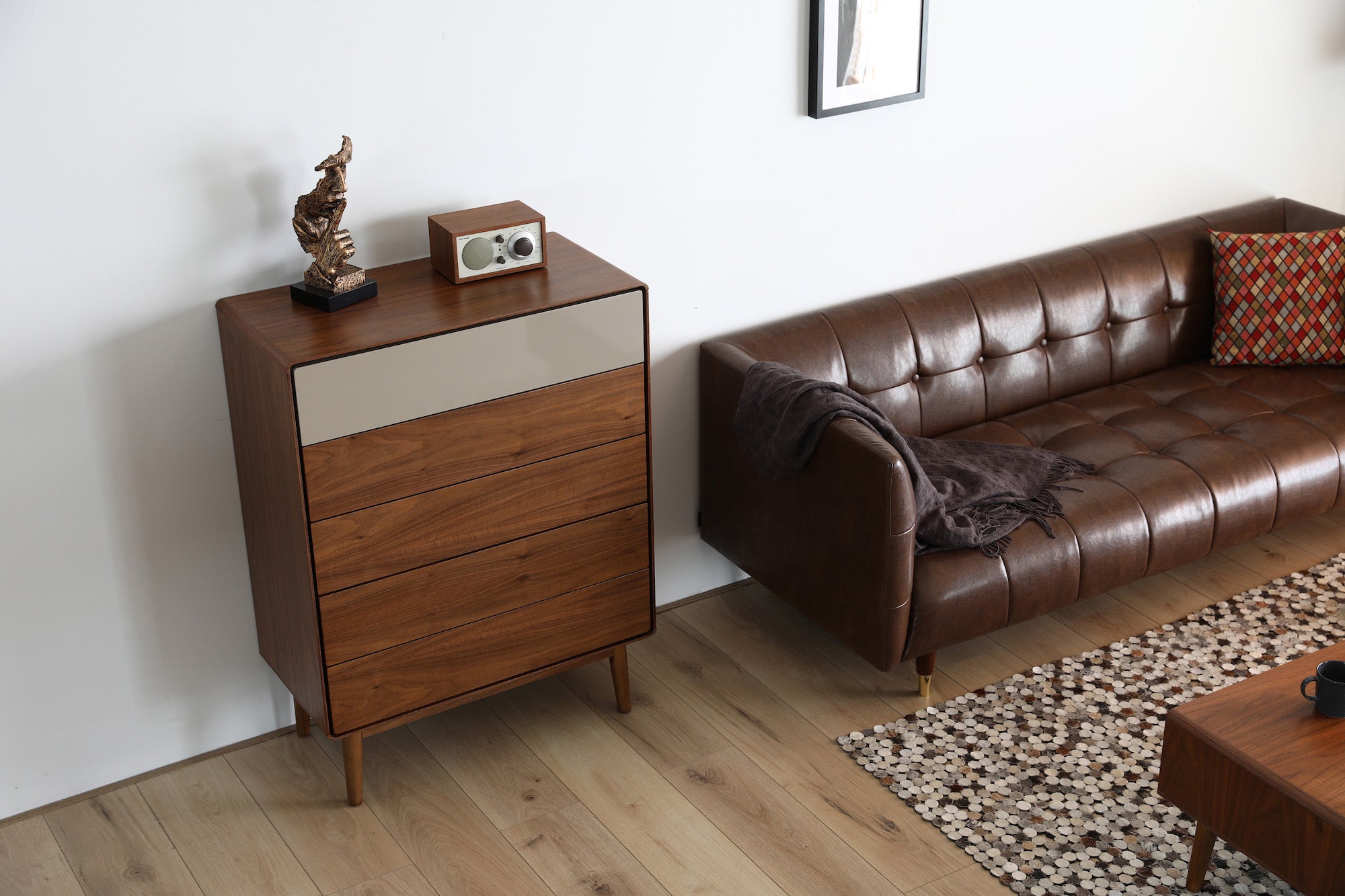 Walnut 5 Drawer Tallboy and brown sofa