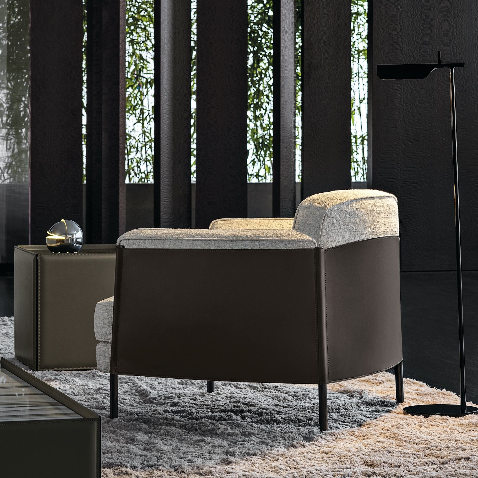 Saddle leather back and sides armchair in black room