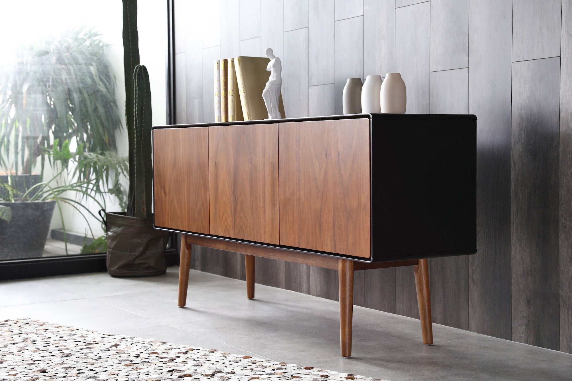 Walnut and black cabinet grey wall