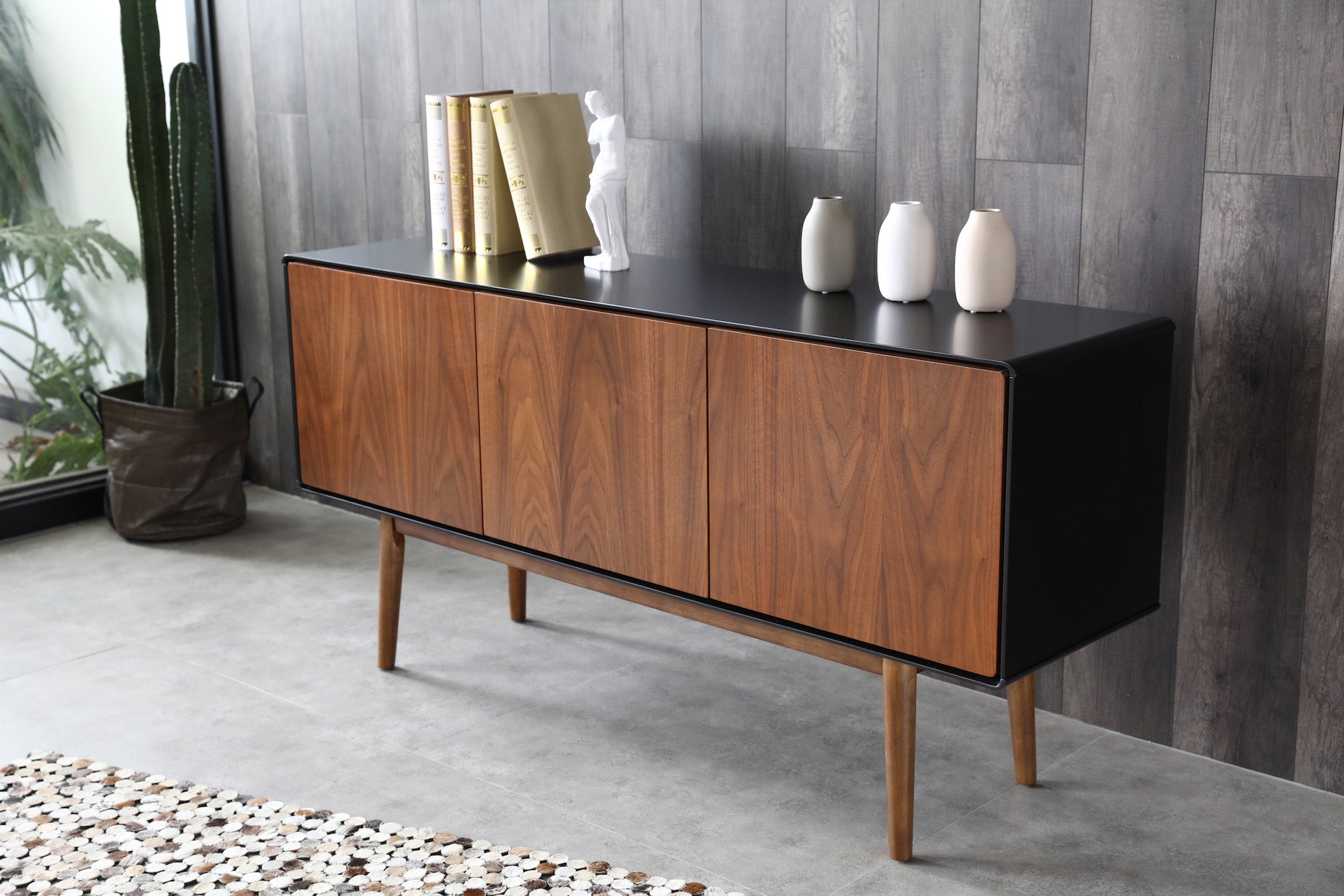 Walnut and black cabinet grey wall