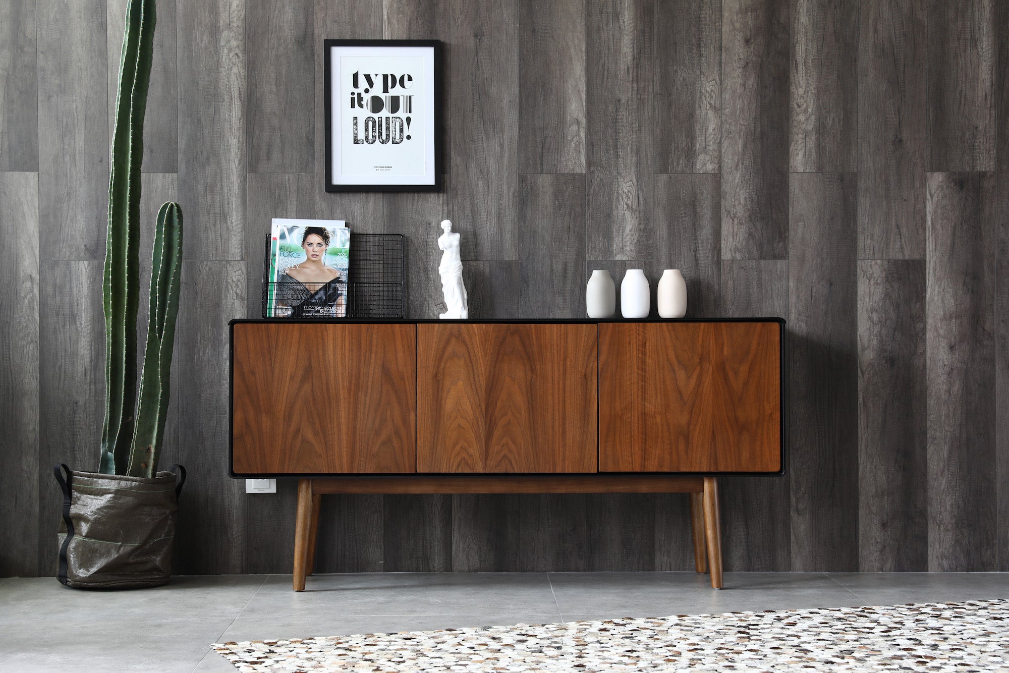 Walnut and black cabinet grey wall